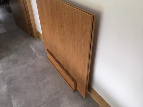 Oak laminate dining top stand in a room setting